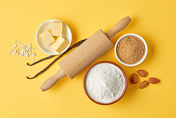 Image showing baking ingredients on yellow background