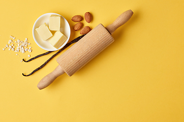 Image showing baking ingredients on yellow background