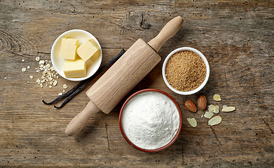 Image showing baking ingredients on wooden table