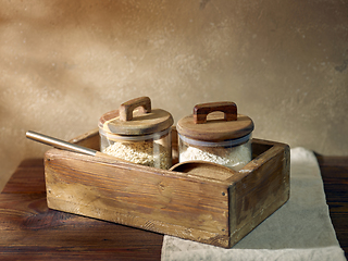 Image showing product storage jars in a wooden box