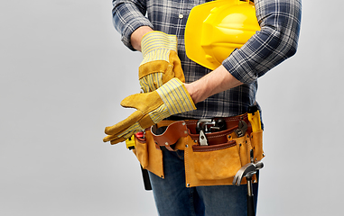 Image showing builder with gloves, helmet and working tools