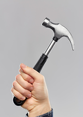 Image showing close up of builder's hand holding hammer