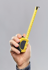 Image showing close up of builder's hand holding building ruler