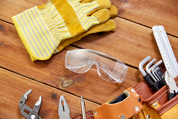 Image showing different work tools in belt on wooden boards