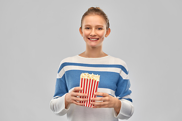 Image showing smiling teenage girl with popcorn