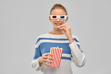 Image showing teenage girl in 3d movie glasses eating popcorn