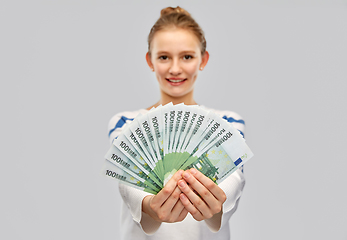 Image showing close up of smiling teenage girl with euro money