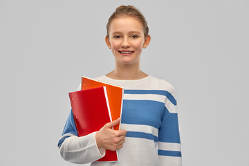 Image showing happy smiling teenage student girl with notebooks