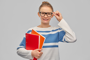 Image showing happy smiling teenage student girl with notebooks