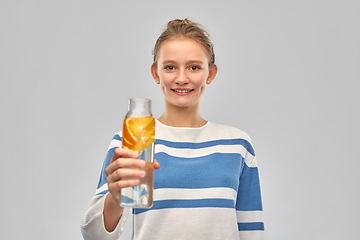 Image showing teenage girl with glass bottle of fruit water