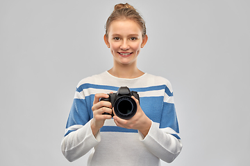 Image showing smiling teenage girl r with digital camera