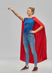 Image showing smiling teenage girl in red superhero cape