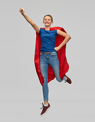 Image showing smiling teenage girl in red superhero cape jumping