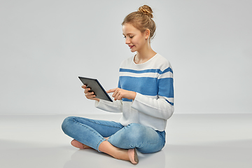 Image showing happy smiling teenage girl using tablet computer