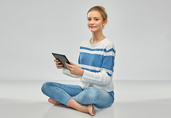 Image showing happy smiling teenage girl using tablet computer