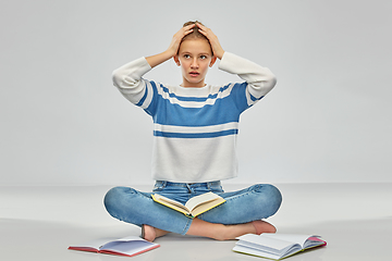 Image showing stressed teenage student girl with books