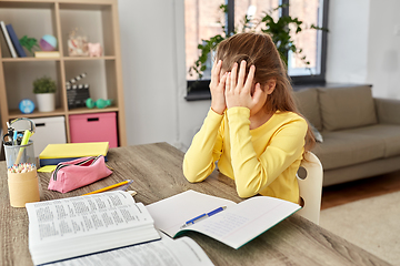 Image showing stressed little student girl learning at home