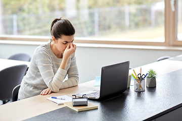 Image showing tired woman with laptop working at home office