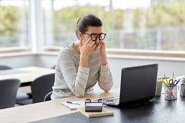 Image showing tired woman with laptop working at home office