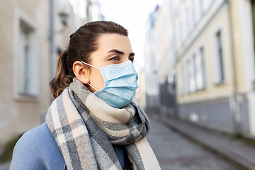 Image showing woman wearing protective medical mask in city