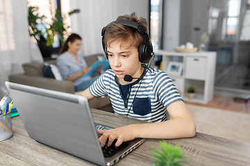 Image showing boy with laptop and headphones at home