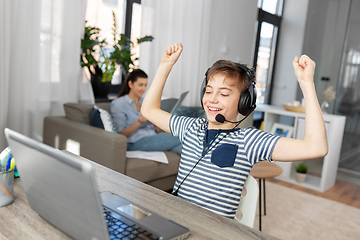 Image showing boy with laptop and headphones at home