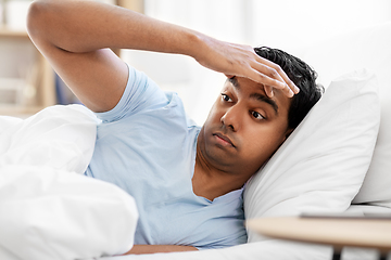 Image showing indian man lying in bed at home