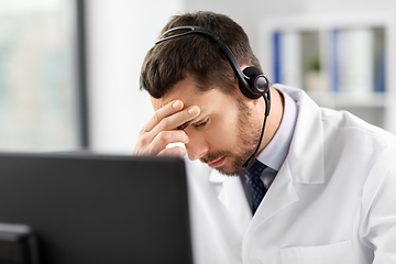 Image showing male doctor with computer and headset at hospital