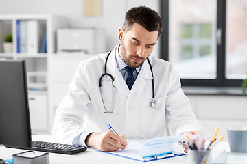 Image showing male doctor with clipboard at hospital