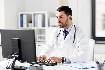 Image showing male doctor with computer working at hospital