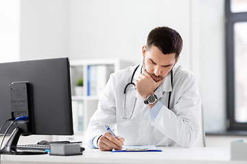 Image showing stressed male doctor with clipboard at hospital