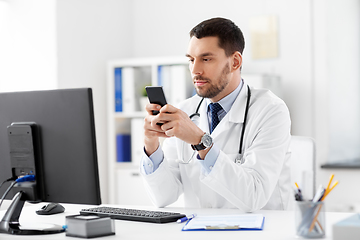 Image showing male doctor with smartphone at hospital