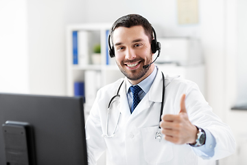 Image showing happy doctor with computer and headset at hospital