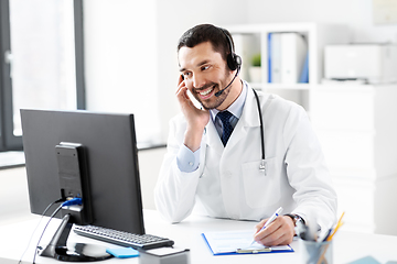 Image showing happy doctor with computer and headset at hospital