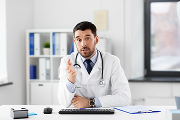 Image showing male doctor having video conference at hospital