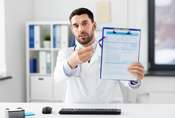 Image showing doctor with clipboard having video call at clinic