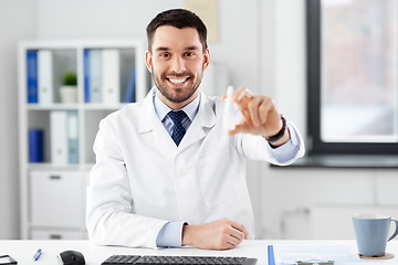 Image showing smiling male doctor with medicine at hospital