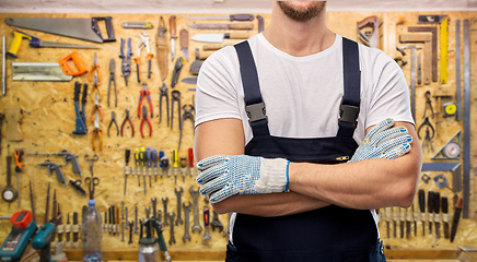 Image showing close up of male builder in overall and gloves