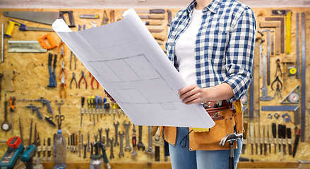 Image showing female builder with blueprint and working tools