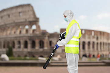 Image showing sanitation worker in hazmat with pressure washer