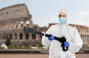 Image showing sanitation worker in hazmat with pressure washer