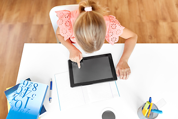 Image showing little student girl using tablet computer at home