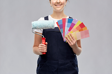 Image showing close up of painter with roller and color charts