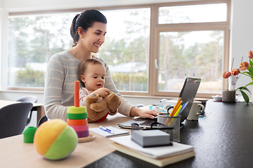 Image showing mother with baby and laptop working at home office