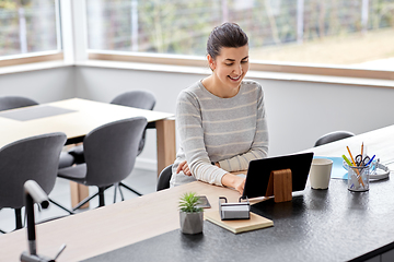 Image showing young woman with tablet pc working at home office