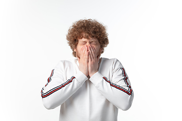 Image showing How coronavirus changed our lives. Young man coughing on white background