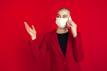 Image showing Portrait of young caucasian bald woman on red background