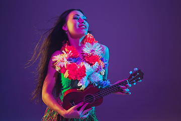 Image showing Fabulous Cinco de Mayo female dancer on purple studio background in neon light