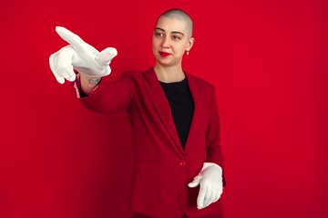 Image showing Portrait of young caucasian bald woman on red background