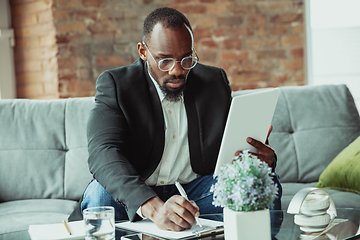 Image showing Businessman or student working from home while being isolated or keep quarantine \'cause of coronavirus COVID-19